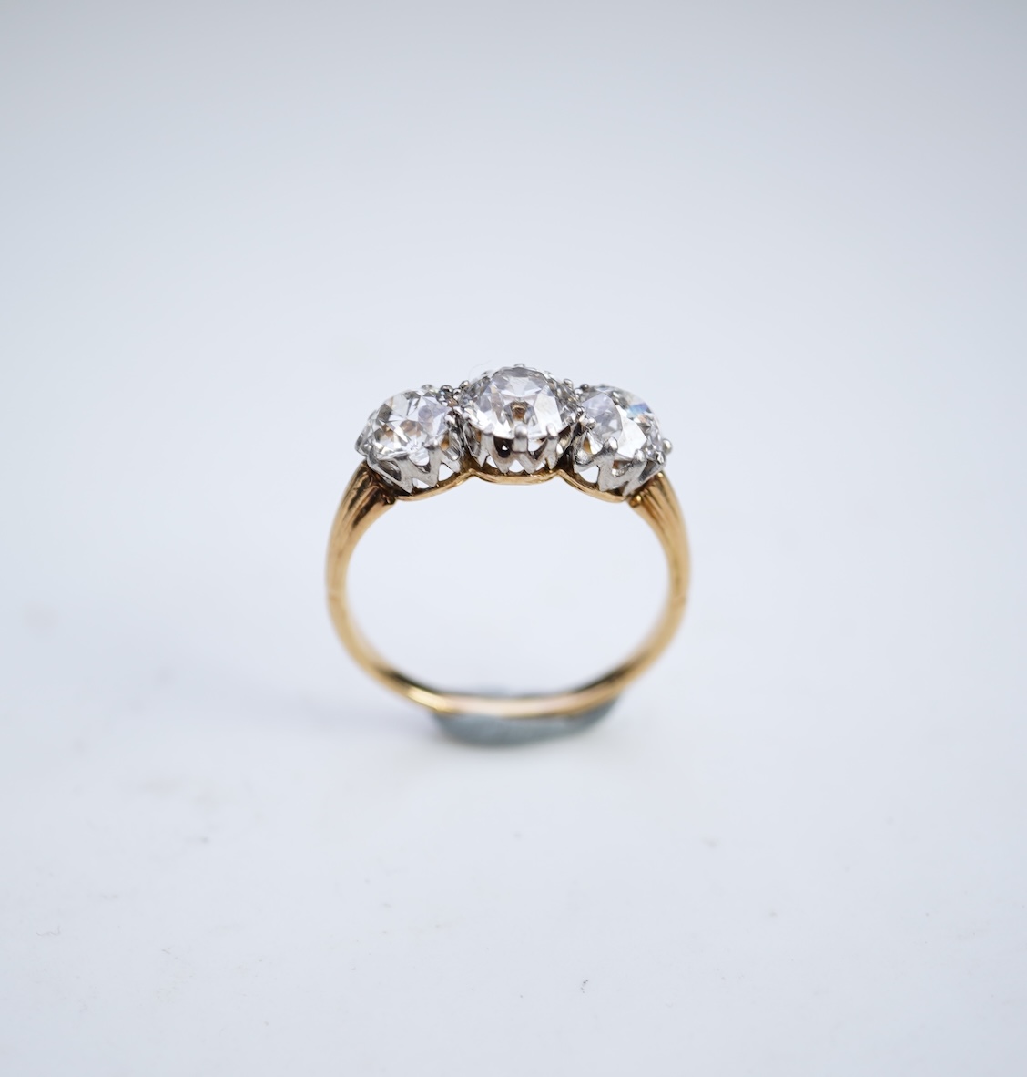 An attractive three-stone diamond ring, early 20th century
